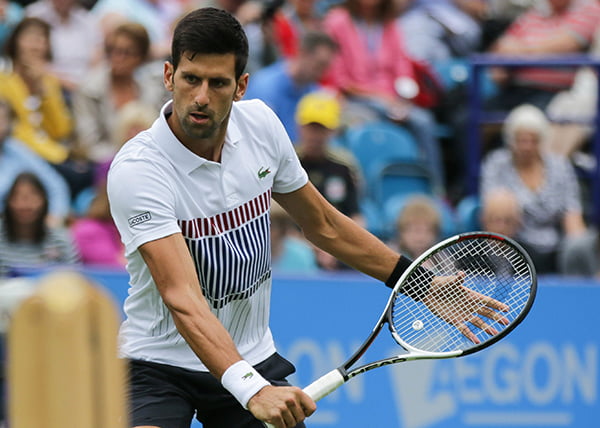 Novak Djokovic hits a volley