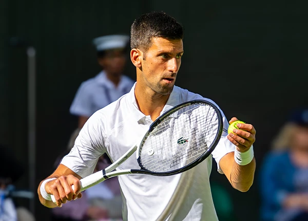 Novak Djokovic serves at Wimbledon 2023